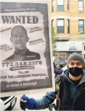  ?? TOM SCHUBA/SUN-TIMES ?? Kyle Frayn holds a sign targeting Ald. Tom Tunney and opposing turning Pilsen into a landmark district on Oct. 25.