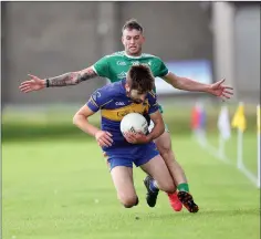  ??  ?? Donard-The Glen’s Liam Monaghan closes in on Carnew’s John Doyle during the IFC semi-final last weekend.