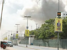  ?? HASSAN ALI ELMI/GETTY-AFP ?? Smoke rises Saturday over the Somali capital of Mogadishu after two car bombings.