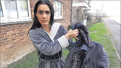  ?? ?? Genty Barton holds up her son’s jacket, left, which itself has developed mould, with growth also on the bathroom ceiling at the Golding Homes flat, right