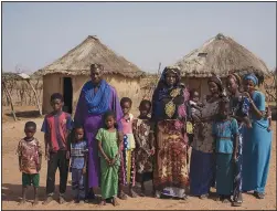  ?? ?? Mamadou Samba Sow (center left), 63, and his wife, Dieynaba Toure (center right), 46, stand for a picture April 13 with their family at their compound in the village of Anndiare.