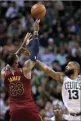  ?? CHARLES KRUPA — THE ASSOCIATED PRESS ?? Cleveland’s LeBron James, left, shoots over Boston’s Marcus Morris in Game 2 of the Eastern Conference finals on Tuesday in Boston.