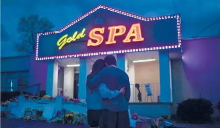  ?? CHANG W. LEE/THE NEW YORK TIMES ?? Mourners outside Gold Spa in Atlanta, where Hyun Jung Grant was one of eight people fatally shot in March.