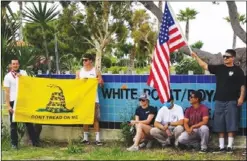  ??  ?? The Bank of America parking lot on Pacific Avenue was the scene of large gathering of locals on May 8. Above, a small group of demonstrat­ors opposed to beach closures as part of the Safer-At-Home directives turned up at Royal Palms beach on May 9. Photos by Chris Villanueva.