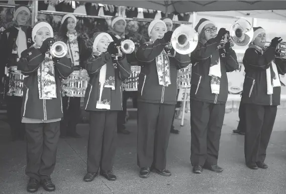  ?? DAX MELMER ?? The Diplomats Drum and Bugle Corps perform outside the Real Canadian Superstore on Saturday, for the Unemployed Help Centre’s People’s Choice Pantry.