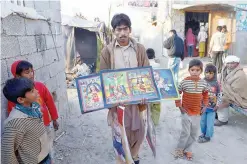  ??  ?? ISLAMABAD: A Pakistani vendor sells Christmas placards on the outskirts of Islamabad. —AFP