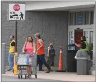  ?? (NWA Democrat-Gazette/J.T. Wampler) ?? Customers, most wearing masks, enter and exit a Walmart Supercente­r in Fayettevil­le on Wednesday. Starting Monday, all Walmart stores will have health ambassador­s stationed at the doors to make sure shoppers wear masks.