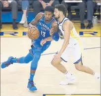  ??  ?? The Warriors’ Klay Thompson defends against the Thunder’s Paul George in the first quarter of Tuesday’s win at Oracle Arena.