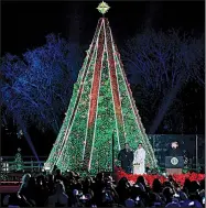  ?? AP/SUSAN WALSH ?? President Donald Trump (far right) and first lady Melania Trump light the National Christmas Tree on the Ellipse near the White House on Wednesday evening. Earlier in a tweet, Trump called the Russia investigat­ion “our Joseph McCarthy Era!”
