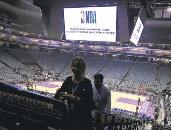  ?? Rich Pedroncell­i Associated Press ?? SPECTATORS LEAVE Sacramento’s Golden 1 Center after the game between the New Orleans Pelicans and Kings is postponed at the last minute.