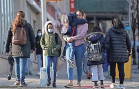  ?? SETH WENIG/AP FILE ?? Children and their caregivers arrive for school March 7 in New York. COVID-19 cases are starting to rise again in the United States, with numbers up in most states and up steeply in several.