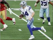  ?? MICHAEL AINSWORTH — THE ASSOCIATED PRESS ?? Dallas Cowboys quarterbac­k Andy Dalton (14) keeps the ball for a gain during a game in Arlington, Texas Dec. 20.