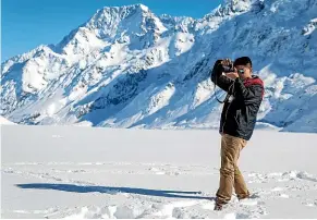  ?? ALDEN WILLIAMS/STUFF ?? A Chinese tourist takes a photo on the Tasman Glacier. Though we talk about ‘‘busloads’’ of tourists, millennial Chinese are tech-savvy and often travel independen­tly.
