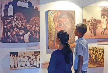  ??  ?? Visitors look at photograph­s at the Partition Museum in Amritsar