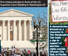  ?? ?? Pro-choice activists in front of the US Supreme Court Building in Washington DC
A demonstrat­or dressed as a character in The Handmaid’s Tale holds a sign in support of abortion rights outside Orlando City Hall, in Florida