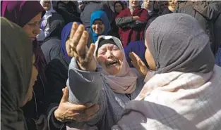  ?? NASSER NASSER AP ?? A mourner cries during the funeral of Abdullah Qalalweh, 25, on Saturday near Jenin, in the West Bank. Israeli forces shot and killed Qalalweh on Friday at a checkpoint.