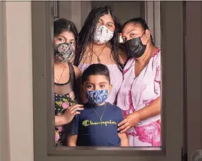  ??  ?? The Martinez-Nava family, clockwise from right, Angelina Martinez-Nava and her children Alesander, 4, Carolina, 12, and Arlene, 14.