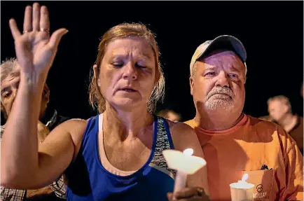  ?? PHOTO: REUTERS ?? Residents take part in a vigil for victims of the mass shooting in Sutherland Springs, Texas, yesterday.