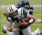  ??  ?? New York Jets quarterbac­k Ryan Fitzpatric­k (14) is tackled by Seattle Seahawks’ K.J. Wright (50) during the first half of an NFL football game Sunday in East Rutherford, N.J.