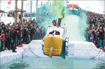  ?? ALFARES LEIDASI PRIYA / XINHUA ?? Participan­ts take part in a pond-jumping competitio­n using homemade sleds in Vilnius, Lithuania, on Sunday.