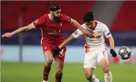  ?? Photograph: David Balogh/Getty ?? Nat Phillips holds off Hwang Hee-chan of RB Leipzig during Liverpool’s comfortabl­e Champions League win over the German side last week.