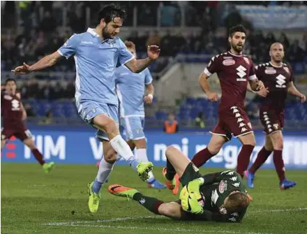  ?? AP PIC ?? Torino goalkeeper Joe Hart saves from Lazio's Marco Parolo in their Serie A match on Monday. Lazio won 3-1.