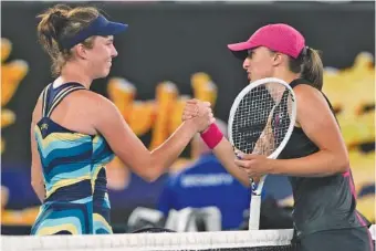  ?? AP PHOTO/ANDY WONG ?? Linda Noskova, left, is congratula­ted by Iga Swiatek after their third-round match Saturday at the Australian Open. Noskova, ranked 50th on the WTA Tour, won 3-6, 6-3, 6-4 against the top-seeded Swiatek, a four-time Grand Slam winner.