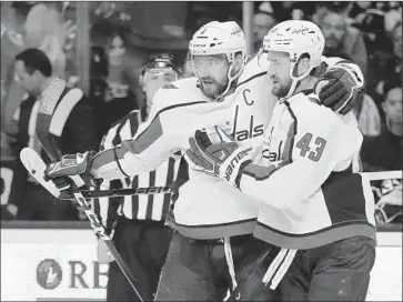  ?? Marcio Jose Sanchez Associated Press ?? WASHINGTON CAPITALS captain Alex Ovechkin, center, celebrates his goal with teammate Tom Wilson during the first period of Monday night’s game. Ovechkin scored again in the second period.