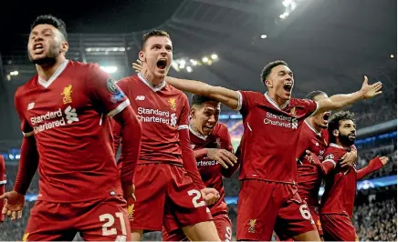  ?? AP ?? Liverpool players Alex Oxlade-Chamberlai­n, left, Andrew Robertson and Trent Alexander-Arnold celebrate during the 2-1 win over Manchester City.