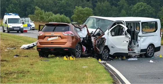  ??  ?? Wreckage: The scene on the A96 yesterday after the fatal collision between a Nissan 4x4 and a minibus carrying Italian tourists