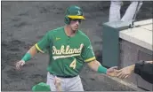  ?? JACK DEMPSEY — THE ASSOCIATED PRESS, FILE ?? The A’s Jake Lamb is congratula­ted after scoring against the Rockies on Tuesday in Denver.