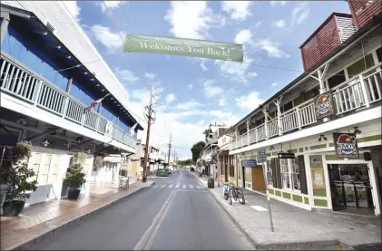  ?? The Maui News / MATTHEW THAYER photo ?? A sign strung across empty Front Street shows the town is ready to welcome folks back. This photo was taken Thursday afternoon.