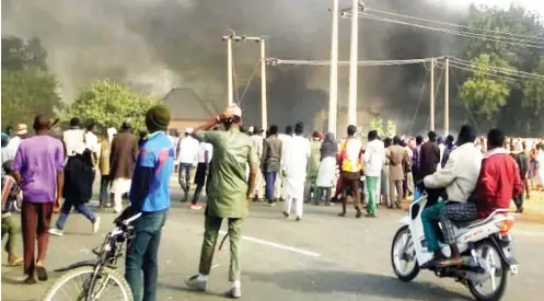  ??  ?? Some property on fire during the Monday’s protest in Tsafe town