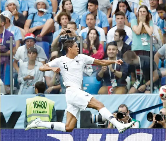  ?? — AP ?? France’s Raphael Varane celebrates after scoring the opening goal against Uruguay in their World Cup quarterfin­al on Friday.