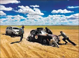  ??  ?? Jill Kirkpatric­k The couple’s Porsche gets stuck in the sand in Zavkhan Province, Mongolia.