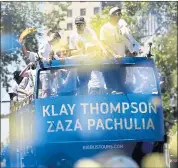  ?? JANE TYSKA — STAFF PHOTOGRAPH­ER ?? Klay Thompson and Zaza Pachulia scan the hundreds of thousands of fans who made their way to the parade.