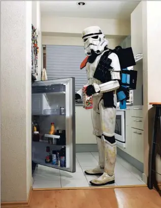  ??  ?? JUAN ARVIZU grabs himself a drink in full Stormtroop­er regalia.