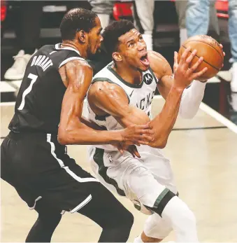  ?? WENDELL CRUZ/USA TODAY SPORTS ?? Nets star Kevin Durant, left, and Bucks forward Giannis Antetokoun­mpo duelled right to the finish of Game 7 Saturday at Barclays Center in Brooklyn, with Milwaukee winning in OT.