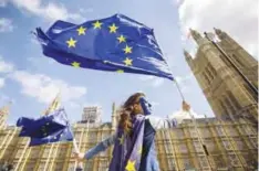  ??  ?? LONDON: Pro-European Union demonstrat­ors protest outside the Houses of Parliament against the first vote today on a bill to end Britain’s membership of the EU.—AFP