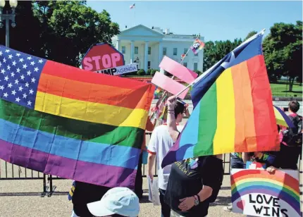  ?? JOSE LUIS MAGANA/AFP/GETTY IMAGES ?? LGBTQ people and allies take part in the Equality March for Unity & Pride parade outside the White House on June 11. White House policies rolling back protection­s for the LGBTQ community have drawn concern.