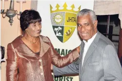  ??  ?? Portia Simpson-Miller embraces John Lynch, chairman of the Jamaica Tourist Board.