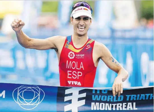  ?? GRAHAM HUGHES/THE CANADIAN PRESS ?? Mario Mola of Spain celebrates after winning the ITU World Triathlon Series race in Montreal on Sunday.