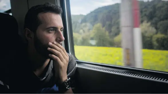  ?? PHOTOS:SANTI PALACIOS/THE ASSOCIATED PRESS ?? In this photo taken Tuesday, Sept.15, 2015, Mohammed al-Haj looks through the train window as he travels near the town of Passau, southern Germany. The Associated Press followed Mohammed on nearly every step of his 2,500-mile journey to Europe in September, starting from Killis, Turkey, where his family lived for a year after escaping Syria.