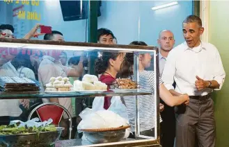  ?? Carolyn Kaster / Associated Press ?? President Barack Obama gave Vietnamese people a photo opp after leaving a restaurant where he had dinner with American chef Anthony Bourdain on Monday in Hanoi, Vietnam.