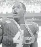  ?? MICHAEL LAUGHLIN/ STAFF PHOTOGRAPH­ER ?? Defensive Jaquan Johnson shows off the Turnover Chain after intercepti­ng a pass for a TD on Saturday.