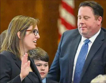  ?? ?? Anne M. Nardacci, left, is sworn in by Judge Brenda Sannes, chief judge of the Northern District of New York, as her husband, local economy entreprene­ur Tom Nardacci, right, holds the Bible. Judge Nardacci is a graduate of Columbia High School in East Greenbush.