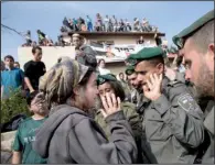  ?? AP/ ODED BALILTY ?? A settler argues with Israeli police Tuesday in the West Bank settlement of Ofra.