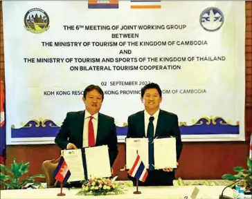  ?? TOURISM MINISTRY ?? Cambodian tourism ministry undersecre­tary of state Thok Sokhom (left) and his Thai counterpar­t Mongkon Wimonrat pose with copies of the joint action plan at the September 2 meeting.