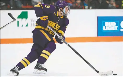  ?? (File Photo/AP/Rick Osentoski) ?? Minnesota State forward Parker Tuomie skates with the puck against Bowling Green during an NCAA college hockey game in 2018 in Bowling Green, Ohio. Tuomie and the Minnesota State hockey team had their chase for the program’s first NCAA championsh­ip ended abruptly a year ago. Tuomie, a native of Germany, now plays profession­ally in Berlin.