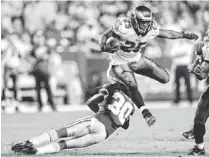  ?? NICK WASS/AP ?? Eagles running back LeSean McCoy leaps over Redskins cornerback E.J. Biggers, breaking free for a touchdown run in the second half of Monday’s game. McCoy finished with 184 yards on 31 carries to open the season with a victory.